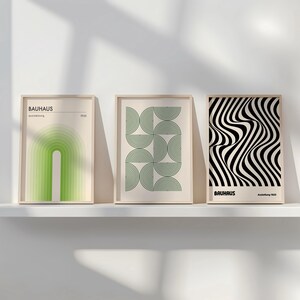 May include: Three framed prints with geometric designs in black, white, and green. The prints are titled "Bauhaus" and feature abstract shapes and patterns.