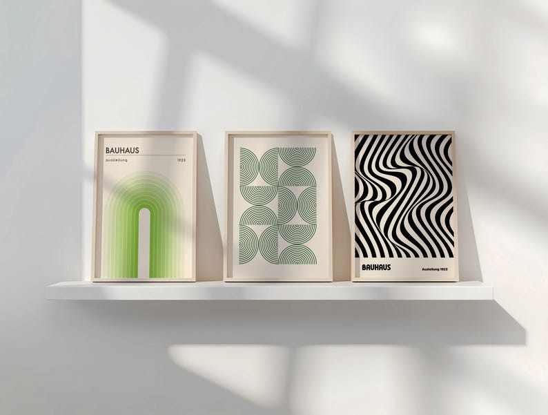 May include: Three framed prints with geometric designs in black, white, and green. The prints are titled "Bauhaus" and feature abstract shapes and patterns.