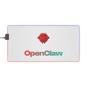 May include: Rectangular white mousepad with a red and blue LED border. The mousepad features the text "OpenClaw" in red and teal, and a red cartoon character. A black USB connector is attached to the left side.