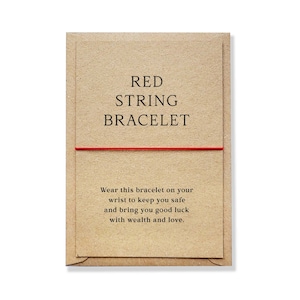 May include: Red string bracelet on a brown card with the text "RED STRING BRACELET" and "Wear this bracelet on your wrist to keep you safe and bring you good luck with wealth and love."