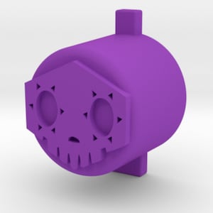 May include: Purple plastic skull-shaped bottle stopper with a small, raised, rectangular top.