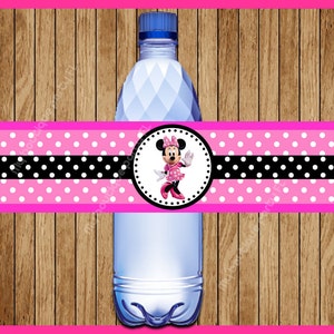 May include: Pink and black polka dot water bottle label with a Minnie Mouse character in a pink dress and white polka dots. The label has a black and white polka dot stripe.
