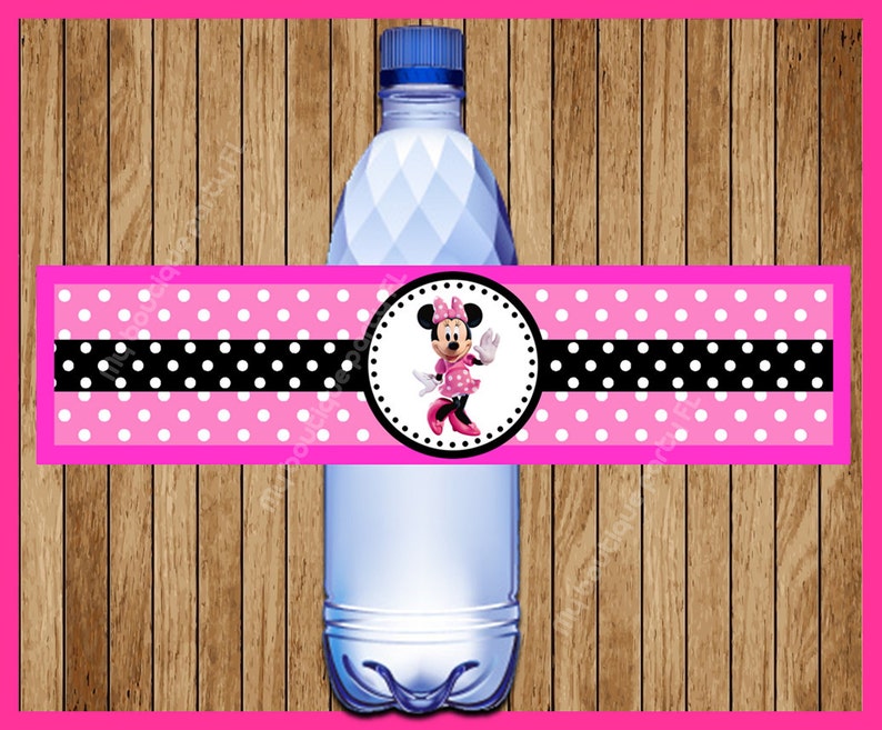 May include: Pink and black polka dot water bottle label with a Minnie Mouse character in a pink dress and white polka dots. The label has a black and white polka dot stripe.