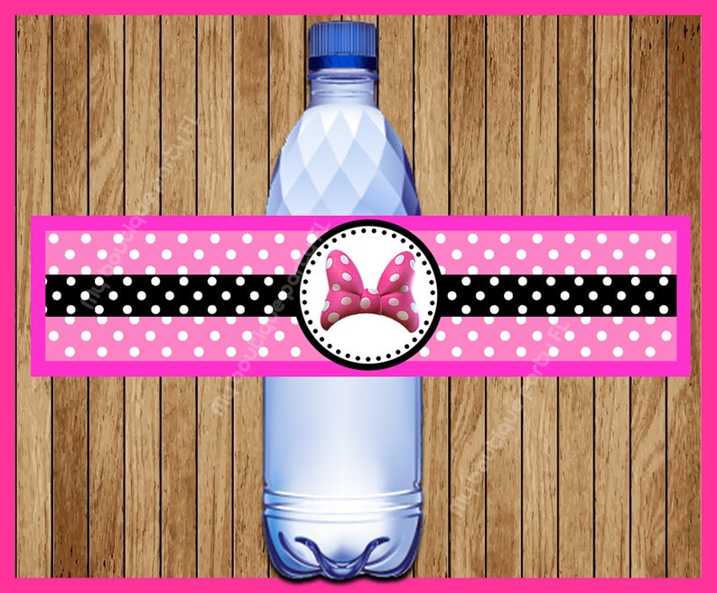 May include: Pink and black polka dot water bottle label with a white bow and red center. The label has a black border and a white circle around the bow.