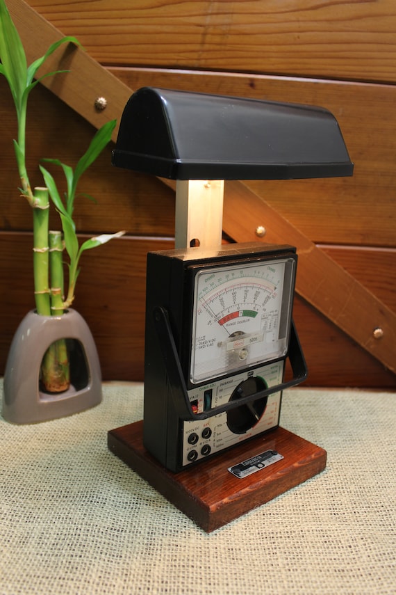 A working vintage multitester — the kind that used to measure volts in a 1950s lab — converted into a glowing steampunk desk lamp with 61 people already in love with it.