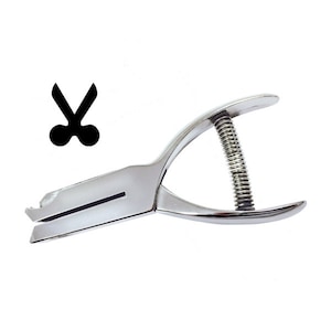 May include: A silver metal punch tool with a spring mechanism. The punch creates a cutout of a pair of scissors.