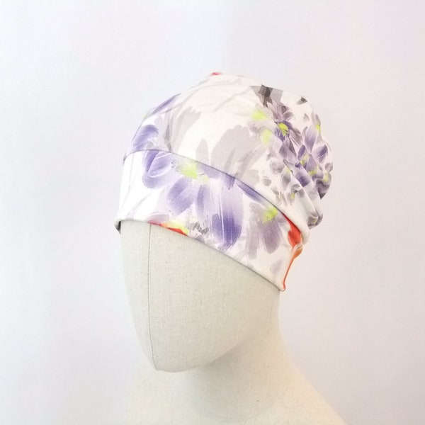 Summer chemo hat for a woman, orange and purple flowers on natural background