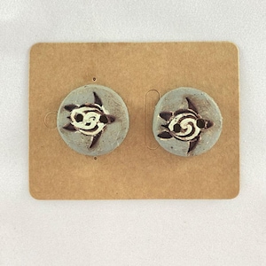 A pair of handmade ceramic buttons