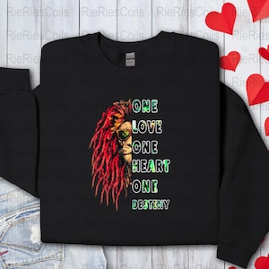May include: Black sweatshirt with a lion's head graphic and the text "One Love One Heart One Destiny".