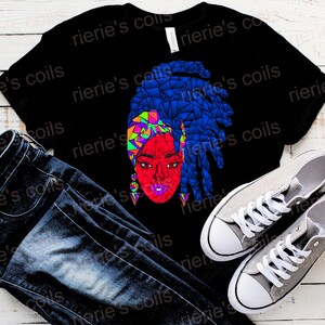 May include: A black t-shirt with a colorful geometric design of a woman with blue hair. The design is in shades of blue, red, green, and yellow.