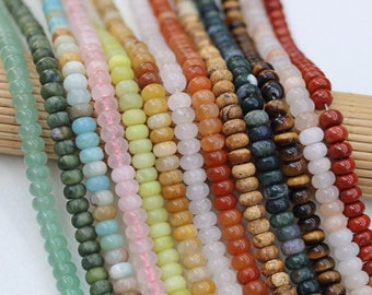 May include: Assortment of colorful gemstone beads, including green, blue, pink, yellow, orange, red, brown, and black. The beads are round and smooth, and they are strung on a string.