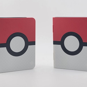 May include: Two red, white, and black card holders. The top section is red, with a black circle and a white center. The bottom section is white with a subtle pattern. The card holders are designed to resemble a popular animated series' ball.