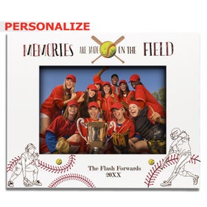 May include: White picture frame with a softball theme. The frame has a photo of a softball team holding a trophy. The text on the frame reads "Memories are made on the field."  The frame also has a softball player illustration and the text "The Flash Forwards 20XX".
