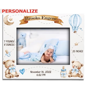 May include: White picture frame with a baby photo. The frame has a moon, stars, teddy bears, and a hot air balloon design. Text includes "Brooks Eugene", "7 pounds 8 ounces", "November 16, 2022 6:52 PM", and "20 inches".