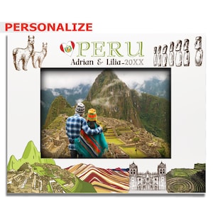 May include: White picture frame with a photo of Machu Picchu, Peru. The frame has illustrations of llamas, the word "PERU", and the text "Adrian & Lilia - 20XX". The word "PERSONALIZE" is at the top left.