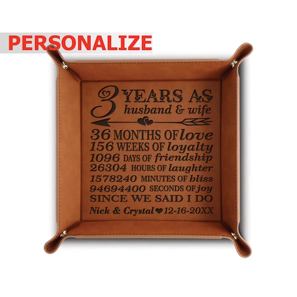 May include: A brown leather valet tray with an engraved message celebrating 3 years of marriage. The message reads "3 years as husband & wife 36 months of love 156 weeks of loyalty 1096 days of friendship 26304 hours of laughter 1578240 minutes of bliss 94694400 seconds of joy since we said I do Nick & Crystal 12-16-20XX".