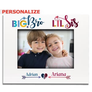 May include: Personalized white photo frame with the text "Big Bro Lil Sis" and a heart design. The frame has a photo of two children, a boy and a girl, with the names "Adrian" and "Ariana" written below the photo.