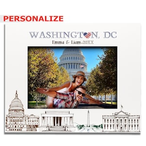 May include: A white photo frame with a drawing of Washington, D.C. landmarks. The frame has a photo of a couple in front of the Capitol Building. The text on the frame reads "WASHINGTON, DC Emma & Liam - 20XX".