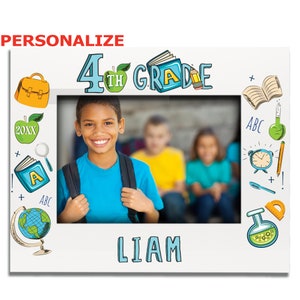 May include: A white photo frame with a blue border and a school-themed design. The frame has a picture of a boy in the center. The frame has the text "4th Grade" at the top and the name "LIAM" at the bottom.