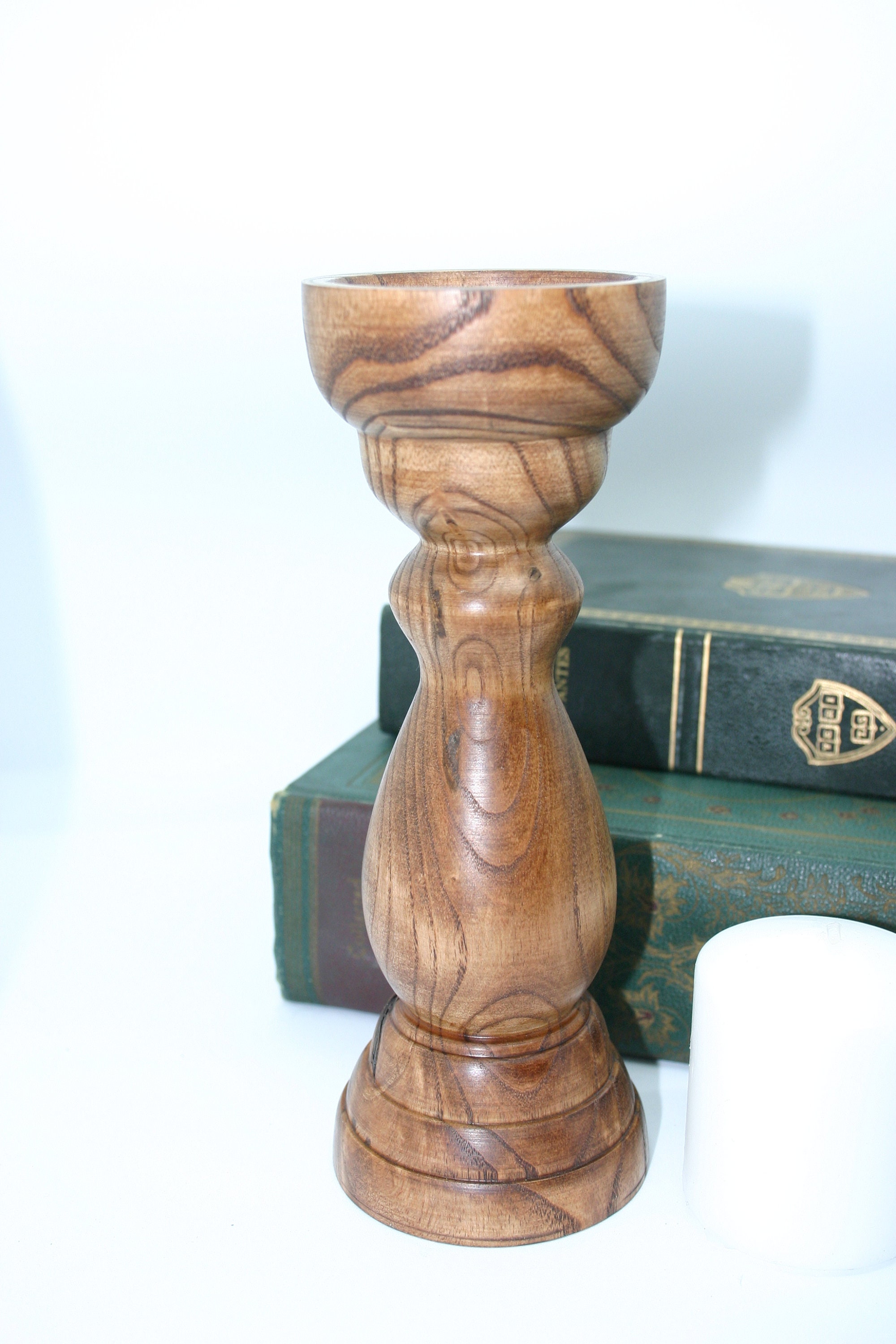 A hand turned Pine candle holder with a lite oak finish. Candle Stick