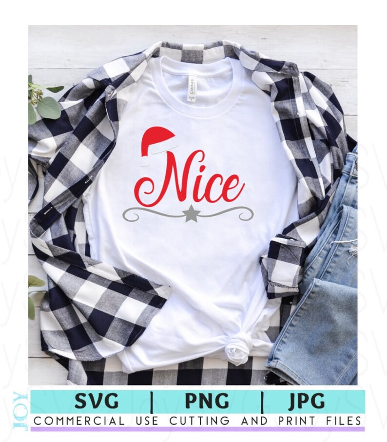 May include: White t-shirt with the word "Nice" in red script, topped with a Santa hat. A gray star and decorative line are below the word. The shirt is layered with a black and white plaid shirt and blue jeans.