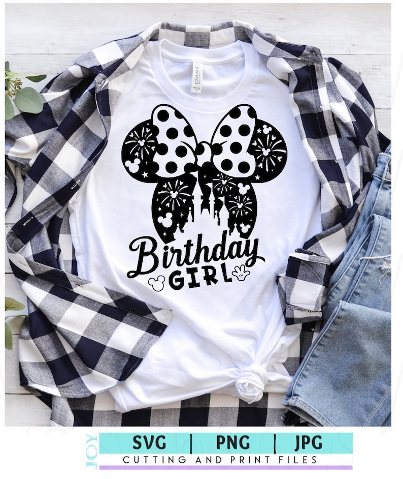 May include: White t-shirt with a black and white polka dot bow with fireworks and a silhouette of Cinderella's castle. The text "Birthday Girl" is below the bow.