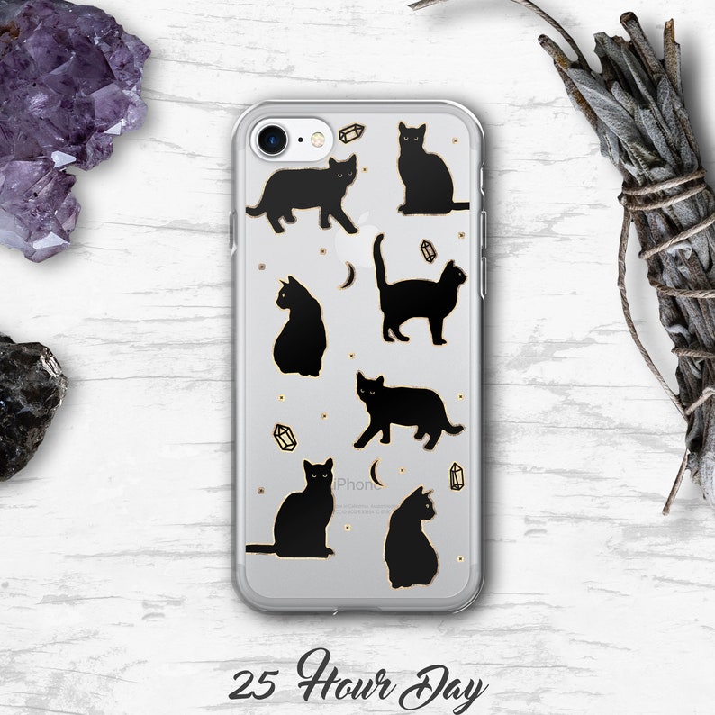 May include: Clear phone case with a black cat design. The case has a gold glitter background with gold crystals and a crescent moon. The text "25 Hour Day" is printed below the phone case.