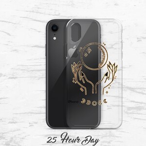 May include: A clear phone case with a gold design of two hands holding a crescent moon with stars. The text "iPhone" is visible on the case.