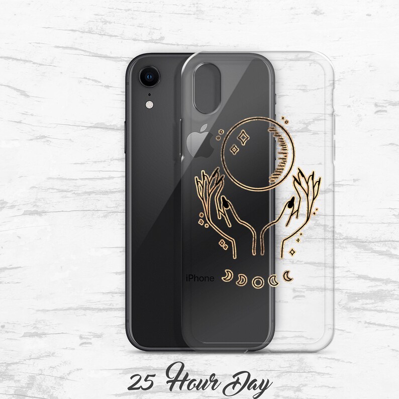 May include: A clear phone case with a gold design of two hands holding a crescent moon with stars. The text "iPhone" is visible on the case.
