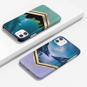 May include: Two phone cases with a galaxy and mountain scene. The cases are blue, green, and purple with gold accents. The text "TED" and "PFM" are on the cases.