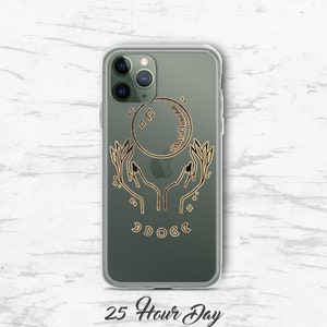 May include: A clear phone case with a gold design of two hands holding a crescent moon with stars. The text "25 Hour Day" is printed below the design.