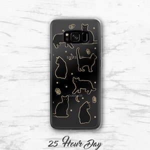May include: A clear phone case with a black background and gold outlines of cats and crystals. The text "Galaxy S8" is visible in the bottom center of the case.