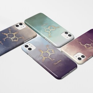 May include: Four smartphone cases with gradient backgrounds in blue, green, purple, and gray. Each case features a gold-colored molecular structure design with the words "Caffeine", "Chocolate", "Dopamine", and another chemical structure.