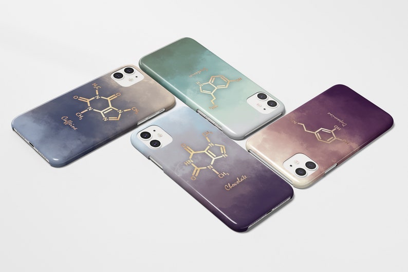 May include: Four smartphone cases with gradient backgrounds in blue, green, purple, and gray. Each case features a gold-colored molecular structure design with the words "Caffeine", "Chocolate", "Dopamine", and another chemical structure.