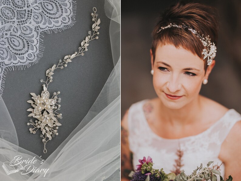 May include: A bride with short brown hair wears a delicate silver bridal headband with crystal and pearl accents. The headband is adorned with small leaves and flowers. The bride is holding a bouquet of flowers.
