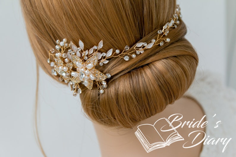 May include: Gold bridal hair comb with pearl and crystal embellishments. The comb is adorned with delicate floral designs and is perfect for adding a touch of sparkle to any bridal hairstyle.