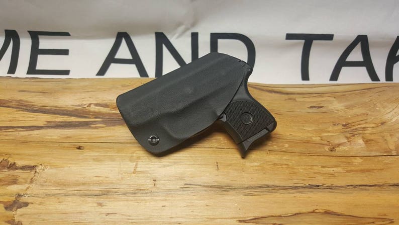 May include: A black leather holster for a small handgun. The holster is designed to be worn inside the waistband.