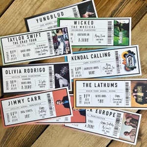 K&ouml;nnte beinhalten: Eine Sammlung von Konzert- und Showtickets mit K&uuml;nstlern wie Taylor Swift und Olivia Rodrigo. Jedes Ticket zeigt Veranstaltungsdetails, Daten und Veranstaltungsort. Die Tickets haben verschiedene Farben und Designs.