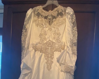 Vintage 1980’s wedding gown. Ivory, satin, illusion netting, pearls/lace/sequins, Long sleeves. Long train