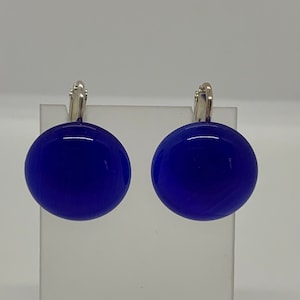 May include: A pair of blue glass earrings with silver hooks.