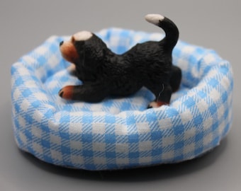 Miniature dog and padded bed