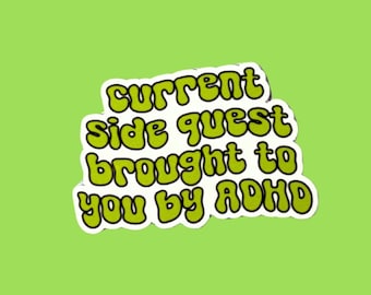 May include: A sticker with the text "current side quest brought to you by ADHD" in green bubble letters with a white outline, set against a lime green background.