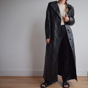 Vintage black leather long trench coat. Originally women’s size S. 90’s era.
