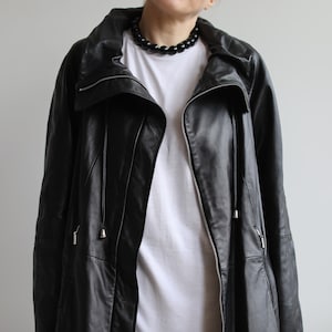 manteau vintage en cuir noir doux beurré. Taille M/L pour femme à l'origine. Époque des années 90.