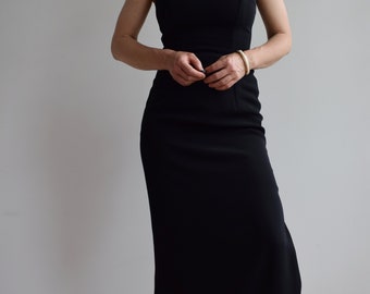 May include: A black sleeveless maxi dress with a simple, fitted silhouette.