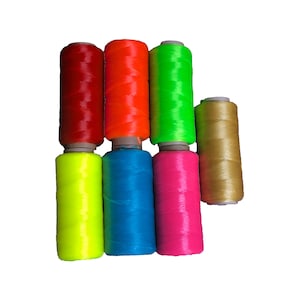 May include: Seven spools of brightly colored thread. The spools are red, orange, green, yellow, blue, pink, and gold.
