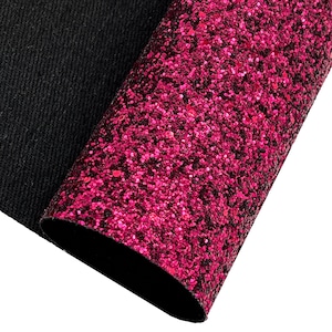 May include: A close-up of a sheet of pink glitter fabric. The fabric has a fine, even texture and is perfect for crafting projects.