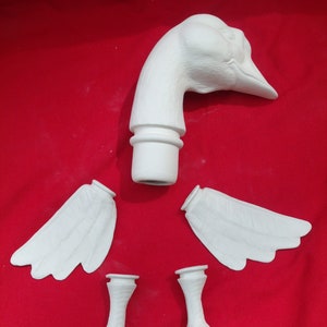 Puede incluir: Un kit de figurita de ganso de cerámica blanca, que consta de una cabeza, dos alas y dos patas. Las piezas están listas para ser ensambladas y pintadas.