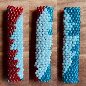 May include: Three beaded bracelets with a white, red, and blue color scheme. The bracelets are made of small, round beads and have a geometric pattern.