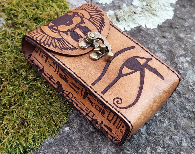 Featured listing image: The Egyptian Magician tan leather tarot card case.  Handmade premium leather tarot deck box featuring Thoth, Winged Scarab, & Hieroglyphs